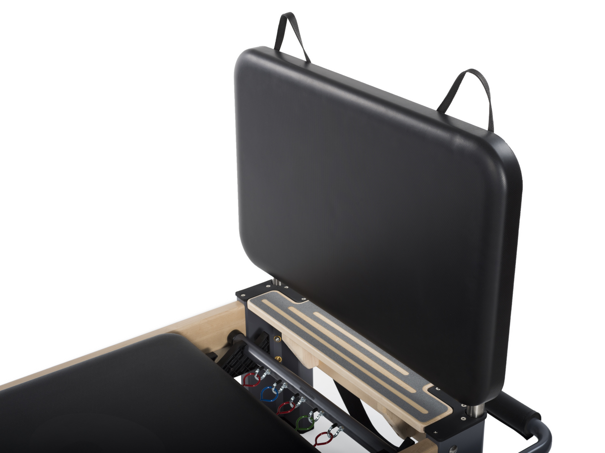 Balanced Body Black Padded Jumpboard, mounted on the Rialto Reformer with springs and handles for Pilates