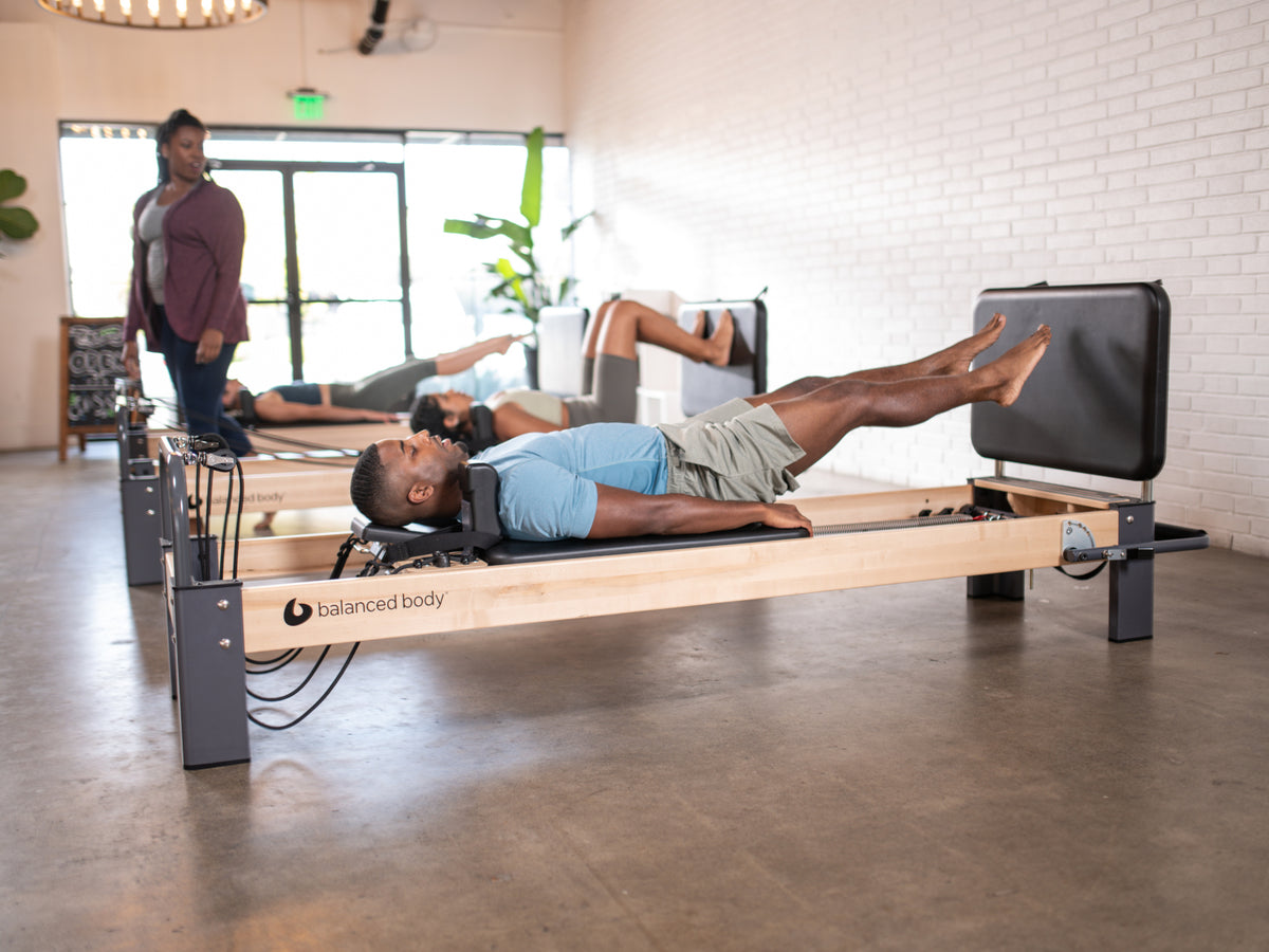Balanced Body Padded Jumpboard on the Rialto Reformer, used in group classes for jumping exercises